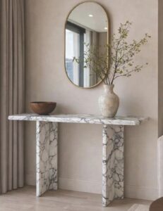 Marble console table with a slim top on two angled panel legs, in white with grey veining