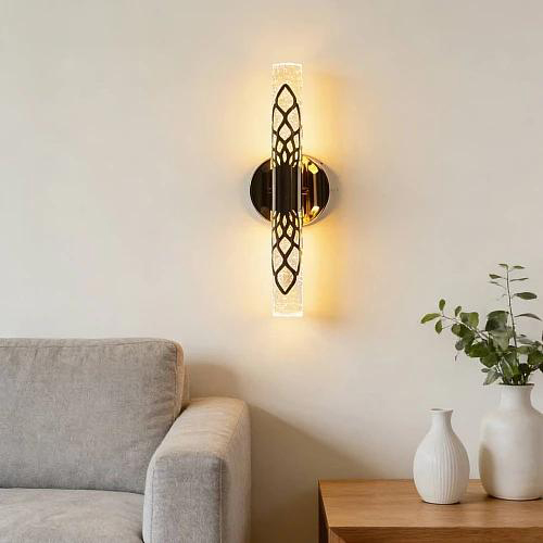 Slim crystal bar wall sconce mounted beside a sofa