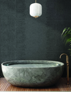 Oval freestanding bathtub in green-grey marble with soft cloudy veining