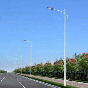 Row of LED street light luminaires on tapered poles along a highway